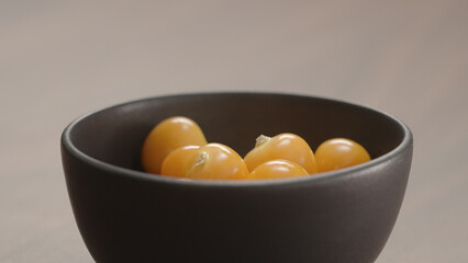 physalis fall into black bowl closeup