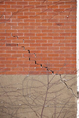 Red Brick Wall and Foundation with Large Crack and crumbling mortar