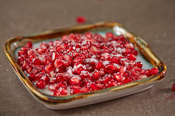 Mixed sugar and pomegranate on a plate