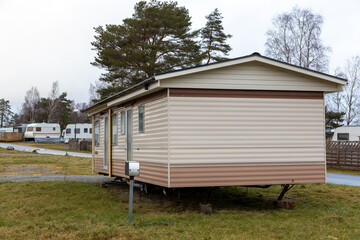 Fototapeta na wymiar Caravan mobile home at a campsite. Grey winter day. No visible people