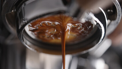 closeup espresso extraction from naked portafilter