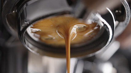 closeup espresso extraction from naked portafilter