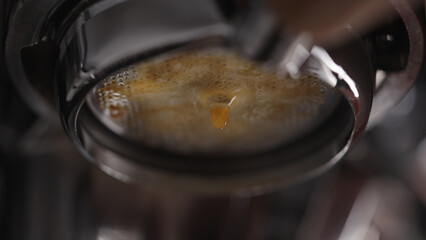 closeup espresso extraction from naked portafilter