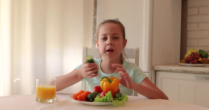 little girl in the kitchen. the child loves vegetables. healthy food concept. vitamins for a child
