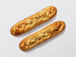 Two rustic baguettes stuffed with garlic