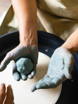 Craftsman is molding the clay into the desired shape on potter's wheel. Made ceramic products. Selective focus.