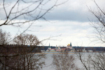 View of the Valdai Monastery on Valdai Lake in cloudy weather, in autumn