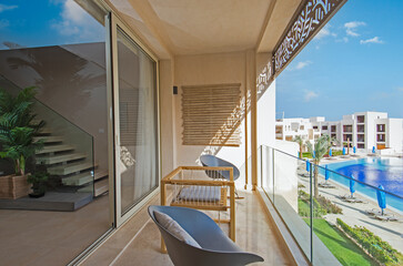 Terrace balcony with chairs in tropical luxury apartment resort