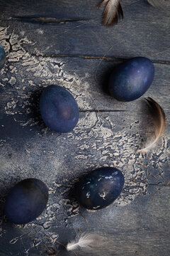 Dyed Easter eggs with marble stone effect painted with natural dye carcade tea from hibiscus flowers on old background