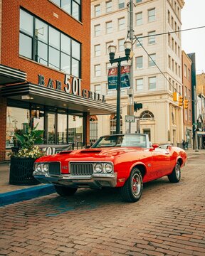 A vintage red Oldsmobile 442, in downtown Flint, Michigan