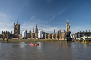 View of restored 2022 iconic Big Ben clock tower and Westminster palace in front of Thames River