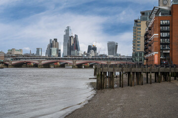 The iconic skyscrapers skyline of Liverpool Street in London across a pier by the River Thames - obrazy, fototapety, plakaty