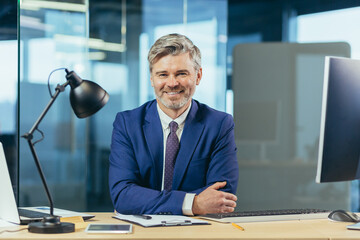 Portrait of successful seo boss, businessman at work, working on computer in modern office, looking...