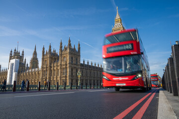 Naklejka na ściany i meble Historic and Iconic Westminster palace by the Westminster bridge with London red bus driving by