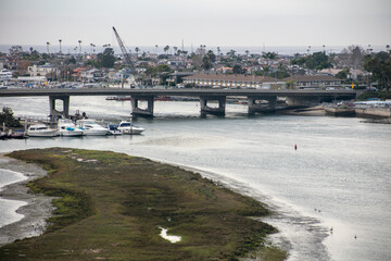 The Newport Beach, California, Back Bay Estuary from the Pacific Ocean Environmental Habitat as Seen from the Bike and Hiking Trail with a View of a main traffic Bridge over the Channel