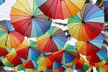 several colorful umbrellas hanging outdoors