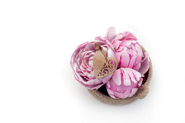 beautiful pink peonies, carved wooden heart on a white background. valentine's day concept, gift for 8 march, congratulations on mother's day