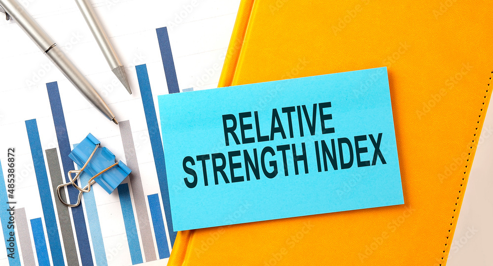 Aufkleber relative strength index text on sticker on the yellow notebook with chart and pen