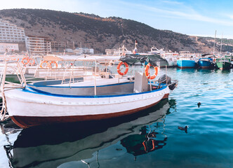 Several colorful boats on a calm sea surface