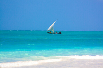 Traditional african sailboat in azure water of Indian ocean. Zanzibar, Tanzania