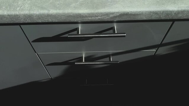 Top view of kitchen grey cabinets with chromatic handles. Shadows and lights.