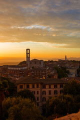 Fototapeta na wymiar Beautiful dawn sky with morning haze over the old city of Perugia, with medieval bell towers and Umbria countryside in the background