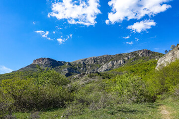 Ancient limestone high mountains of rounded shape in the air haze. Crimea. Russia.