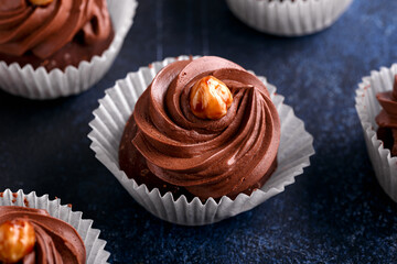 Meringue, pavlova chocolate cupcakes with cream and nuts
