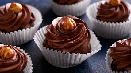 Meringue, pavlova chocolate cupcakes with cream and nuts