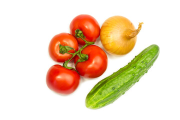 Red tomatoes, onion and green cucumber on a white background.