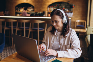 Woman in cafe work with notebook. Business work, education process, online communication, freelance concept