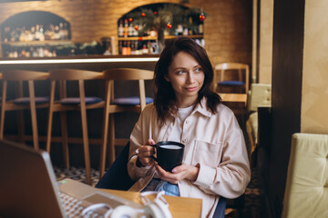 Woman with cup of coffee in cafe. Business work, education process, online communication, freelance concept