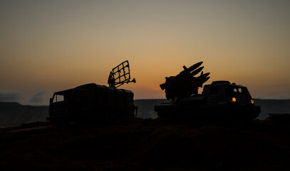 Creative artwork decoration. Silhouette of mobile air defence truck with radar antenna during...