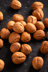 raw walnut in shell on old rustic background
