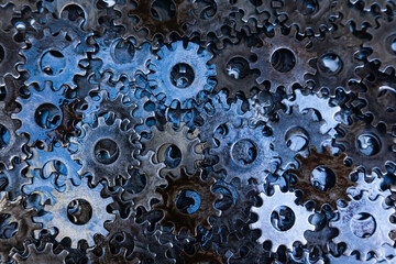 Lots of new steel gears in oil close-up.