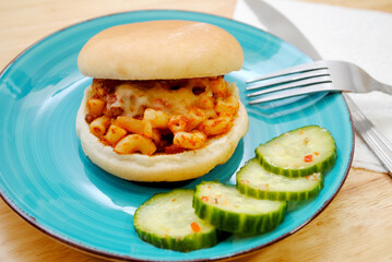 Macaroni Sandwich Served on a Blue Plated with Cucumber Salad