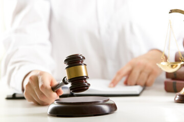 Lawyer working with contract papers and wooden gavel on tabel in courtroom. justice and law ,attorney, court judge concept.