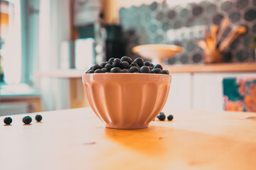 bowl of fresh blueberries on rustic kitchen table