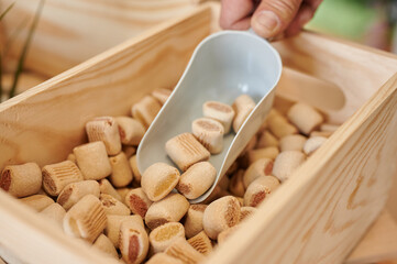 human hand grabbing a handful of natural dog treats in bulk