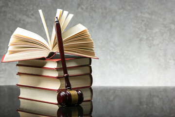 Legal Law and Justice concept - Open law book with a wooden judges gavel on table in a courtroom or...
