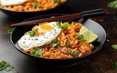 Kimchi fried rice with fried egg and bacon. Korean food