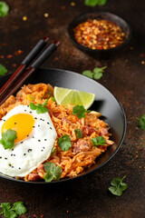 Kimchi fried rice with fried egg and bacon. Korean food