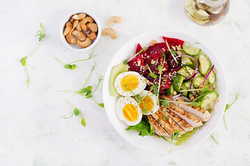 Healthy breakfast. Boiled eggs salad with greens, cucumbers, beetroot and grilled chicken fillet...