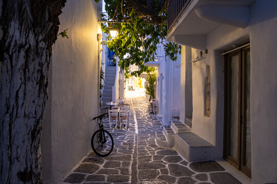 Cafe outdoor illuminated lantern, shadow from trees at Paros island Naousa village Cyclades Greece.