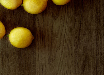 Fresh lemons from the garden on wooden background