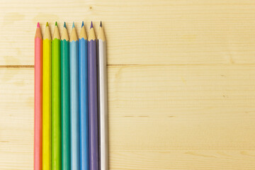 Color pencils on a light wooden background