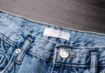 Blank clothing label on denim jeans texture. Label with empty space for text