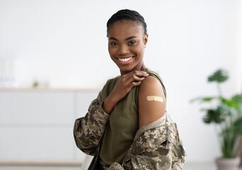 Vaccination Concept. Happy Black Military Woman Showing Arm With Adhesive Bandage