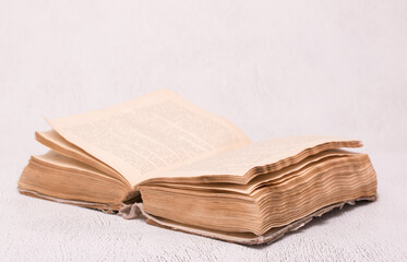 Antique open book on a light table background. Education and science. Knowledge of old Tielerature. Copy space with space for text.