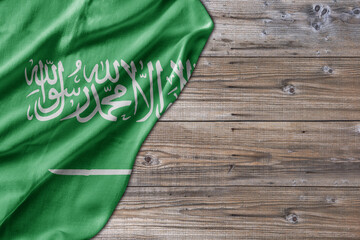 Wooden pattern old nature table board with Saudi Arabia flag